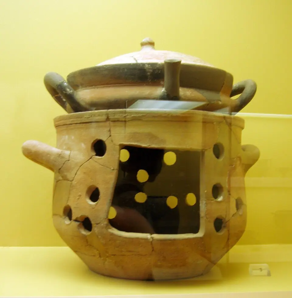 Ancient Greek terracotta brazier and lopas cooking pan displayed in Athens