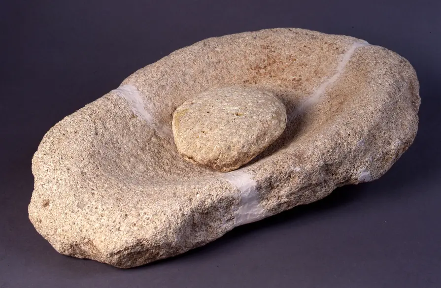 Neolithic sandstone quern with a smaller handstone used for grinding grain